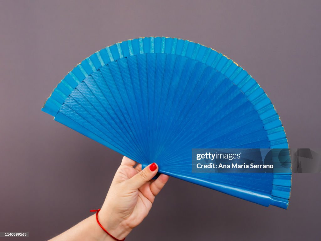 A person with a Spanish fan in her hand