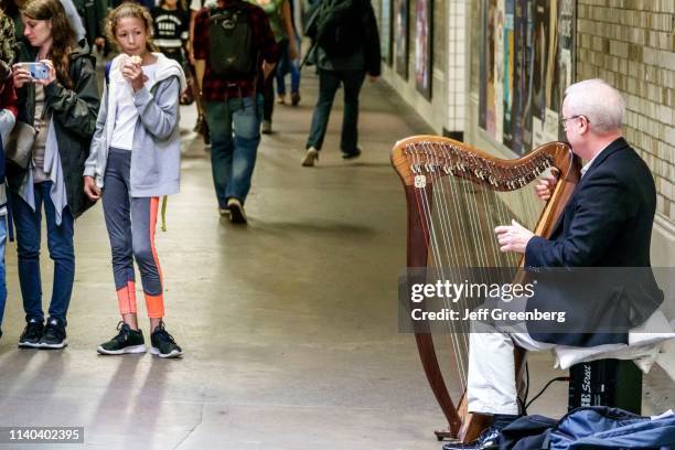 London, Kensington, South Kensington Underground subway Busker playing the Harp.