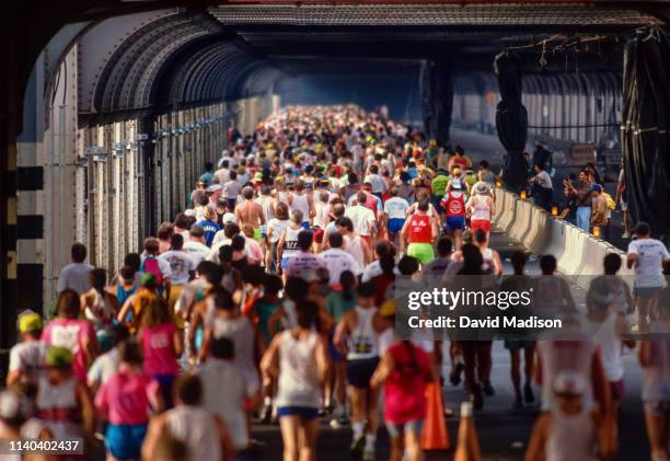 Runners competing in the 1990 New York City Marathon cross the Queensboro Bridge to Manhattan on November 4, 1990 in New York, New York.