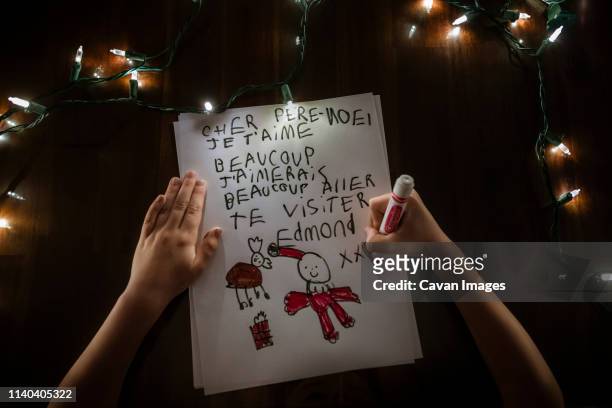 young boy faceless writing a letter to santa claus for christmas - canada christmas ストックフォトと画像