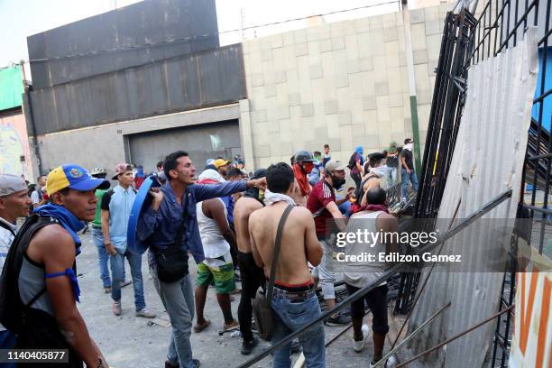 Pro-Guaidó demonstrators clash with Pro-Government military police officers near La Carlota air force on April 30, 2019 in Caracas, Venezuela....
