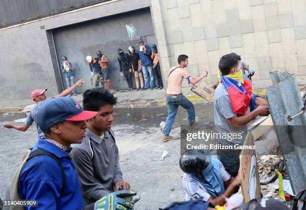 Pro-Guaidó demonstrators clash with Pro-Government military police officers near La Carlota air force on April 30, 2019 in Caracas, Venezuela....