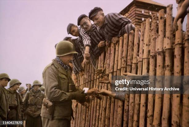 Enlisted Man of Seventh US Army Giving Cigarettes to Liberated Prisoners, Dachau, Germany, Central Europe Campaign, Western Allied Invasion of...