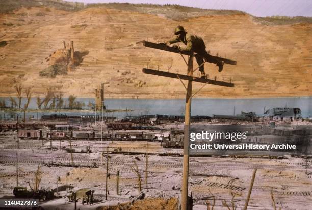 Lineman of Signal Corps Construction Battalion Fastening Wire to Insulator, Bingen on the Rhine, Germany, Central Europe Campaign, Western Allied...
