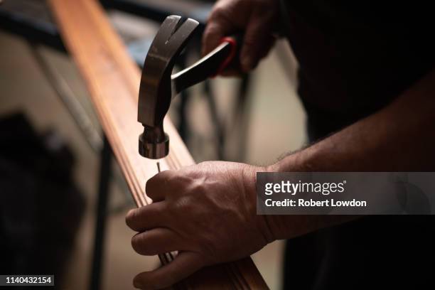 person hammer nails - martillo herramienta de mano fotografías e imágenes de stock