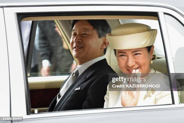 Japan's new Emperor Naruhito and Empress Masako arrive back at the Imperial Palace in Tokyo on May 1, 2019. - Japan's new Emperor Naruhito formally...