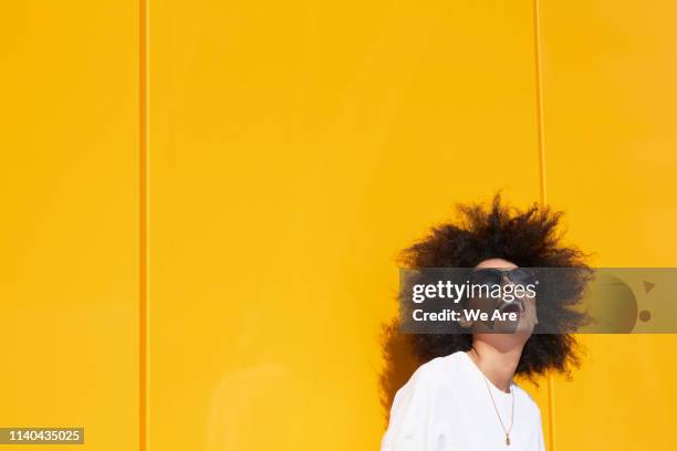 carefree woman with yellow background - monochrome clothing stock pictures, royalty-free photos & images