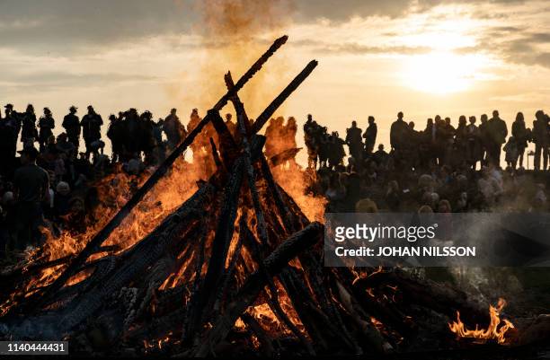 People gather around a May bonfire celebrating Walpurgis Night in Malmo, southern Sweden, on April 30, 2019. - Walpurgis Night in Sweden is a...