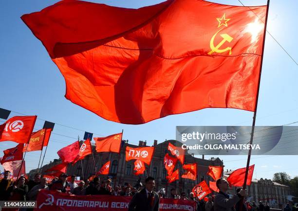 Russian Communist supporters march along Nevsky Avenue during a May Day rally in Saint Petersburg on May 1, 2019.