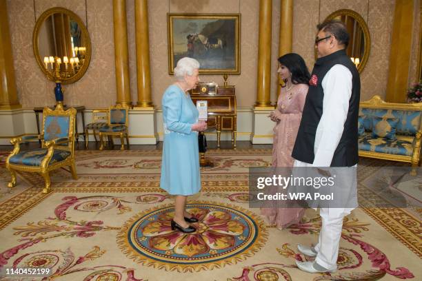 Queen Elizabeth II receives the High Commissioner of Bangladesh Saida Muna Tasneem and Tauhidul Chaudhury during an audience at Buckingham Palace on...