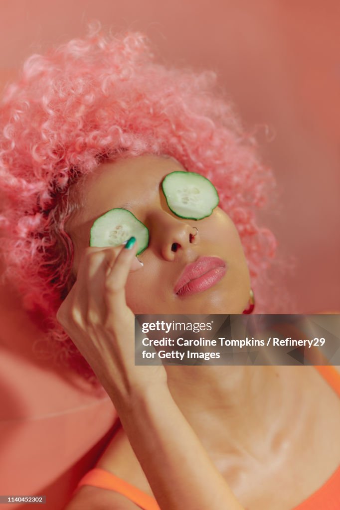 Portrait Of Young Confident Women With Cucumbers On Eyes