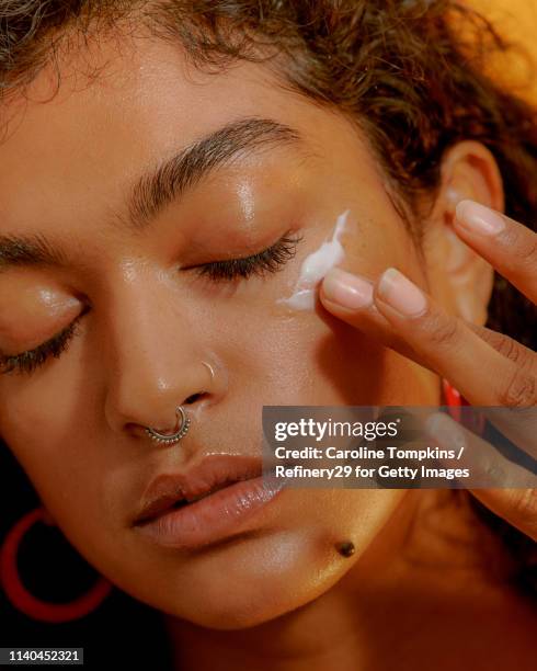 portrait of a young confident woman applying eye cream - noapologiescollection 個照片及圖片檔