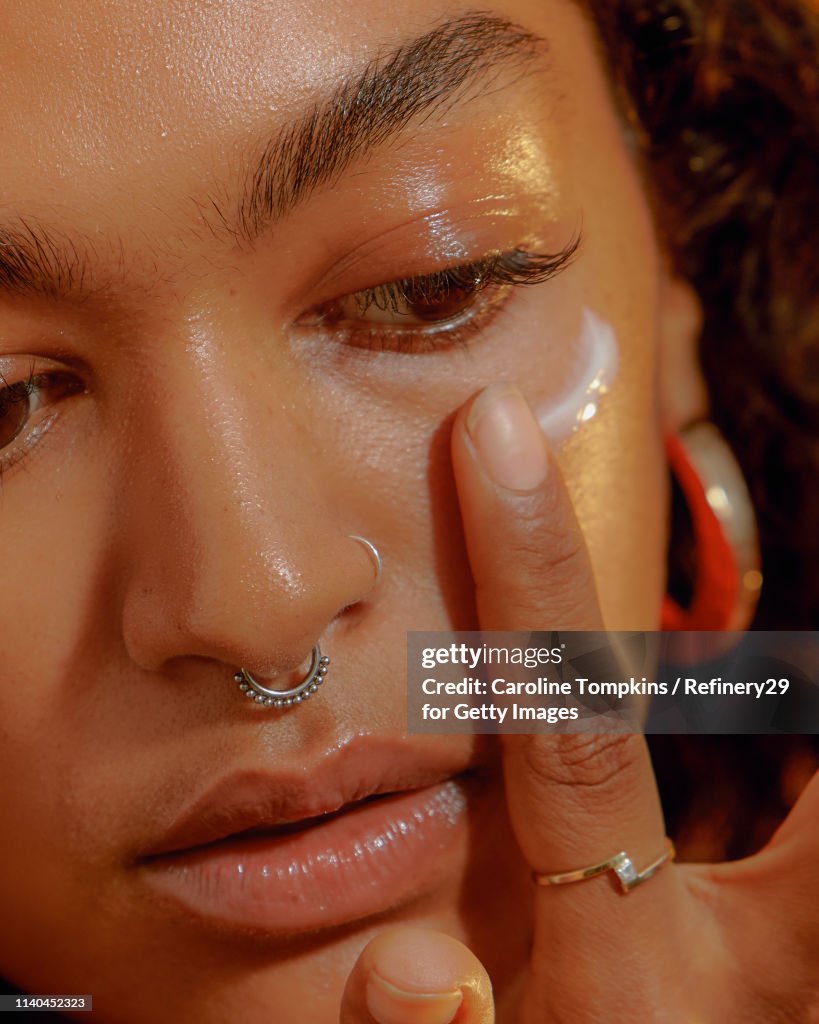Closeup of a Young Confident Woman Applying Eye Cream