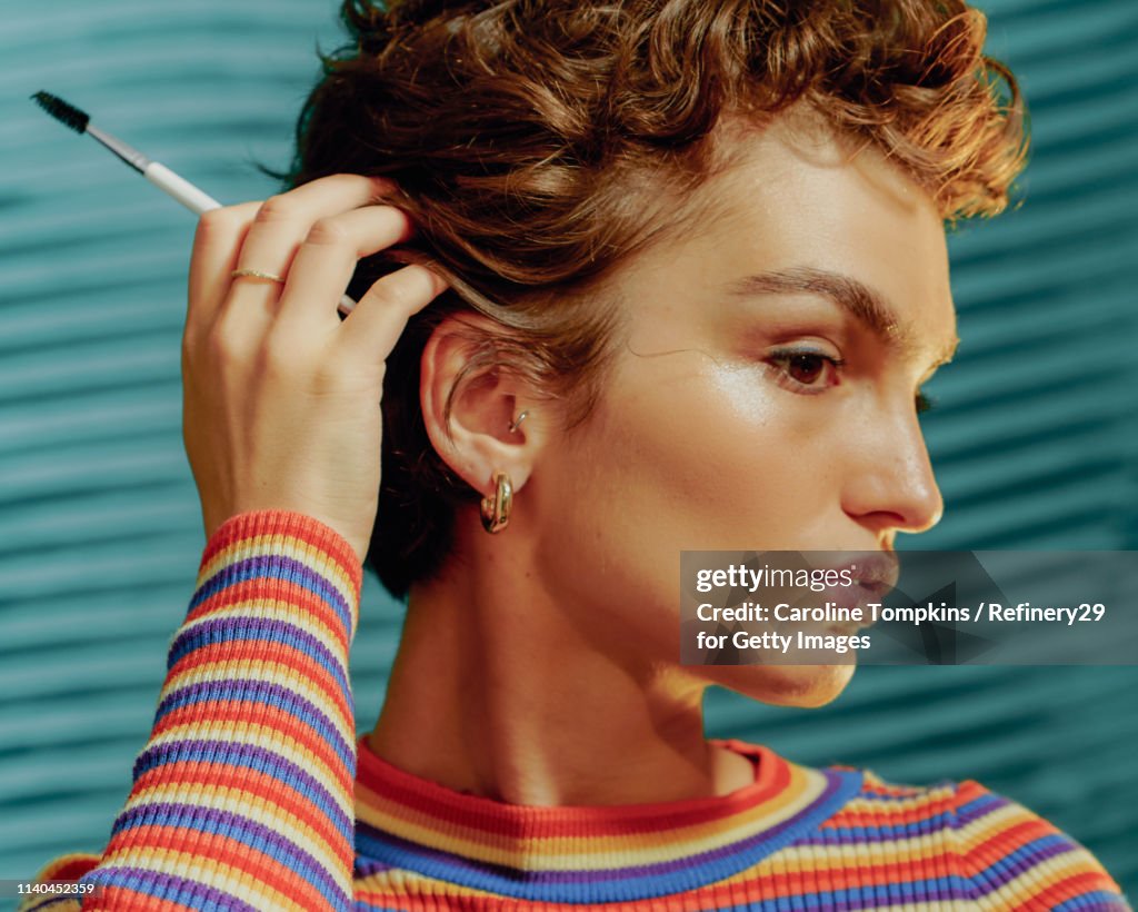 Portrait of a Young Confident Woman Touching her Hair