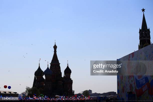 Russian people with balloons and flags take part in a rally to mark May Day, International Workers' Day, at Red Square, in Moscow, Russia on May 1,...