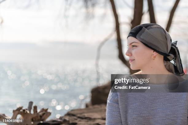 portrait of a beautiful young woman with cancer - cancer survivor stock pictures, royalty-free photos & images