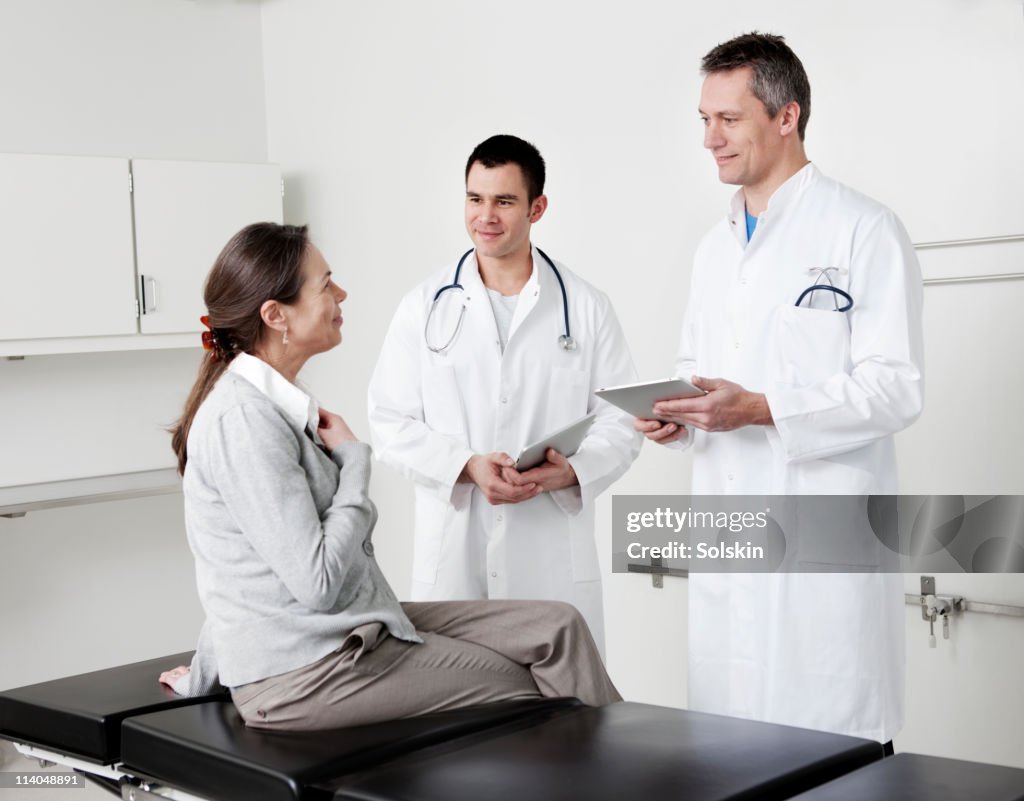 Doctors in conversation with patient