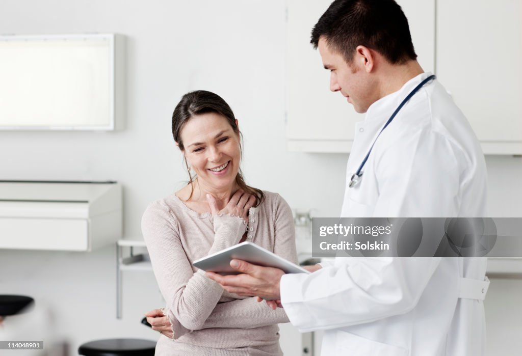 Doctor showing tablet screen to patient
