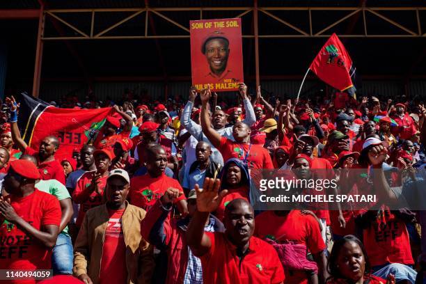 Supporter of the South African opposition party Economic Freedom Fighters hold a placard depicting party leader Julius Malema ahead a campaign rally...