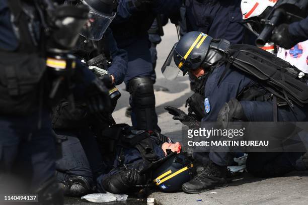 Member of the French anti-riot police CRS receives medication after being injured during clashes with demonstrators on the sidelines of the annual...