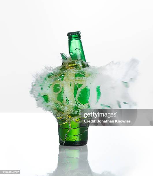 a beer bottle exploding on  a white background - breaking habits ストックフォトと画像