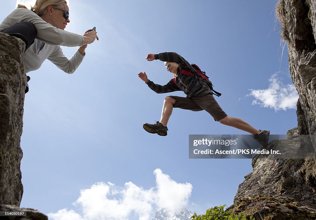 Teenage boy leaps across gap while mom takes pict