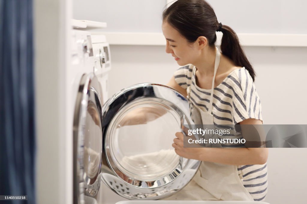 Woman washing cloth with washing machine