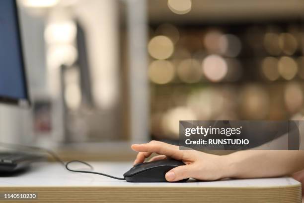 woman's hand on computer mouse, close-up - computer mouse ストックフォトと画像