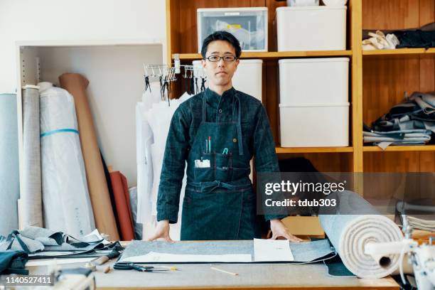 portrait of a mid adult tailor in his design studio that produces denim products - tailor stock pictures, royalty-free photos & images