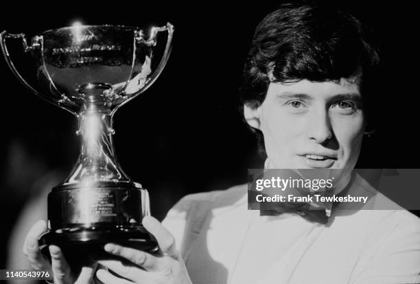 English professional snooker Jimmy White holding his trophy for winning the non-ranking snooker tournament 'Benson & Hedges Masters', Wembley...