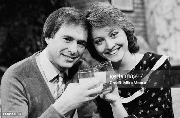 English journalists and broadcasters Nick Owen and Anne Diamond having a drink, UK, 1st February 1984.
