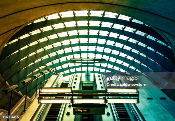 futuristic modern architecture at canary wharf subway station, london, uk - canary wharf railway station stock pictures, royalty-free photos & images