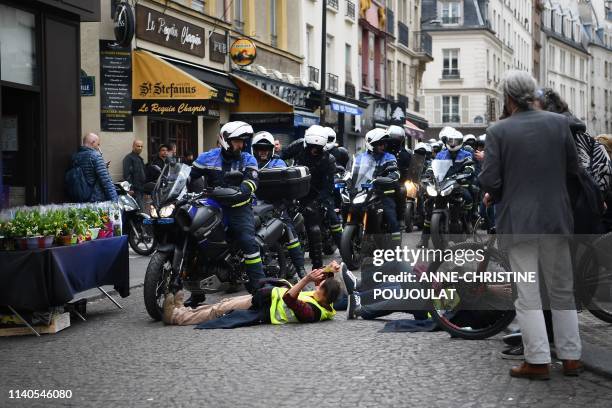 Protesters taking part in an event called "BenallApero", on May 1 prevent police from accessing the Contrescarpe square in Paris, a site where a...