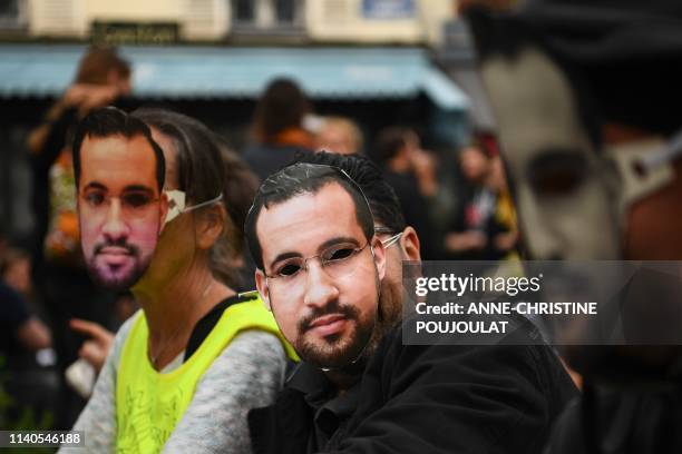 Protesters wearing masks depicting Alexandre Benalla, a French president's former bodyguard had been caught on video roughing up protesters during a...