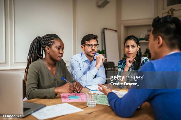 millennial investors brainstorming during business meeting. - crowdfunding stock pictures, royalty-free photos & images