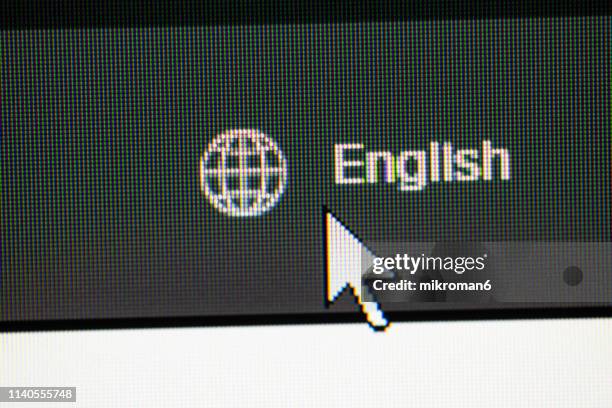 clicking on english language web button on website - idiomas imagens e fotografias de stock