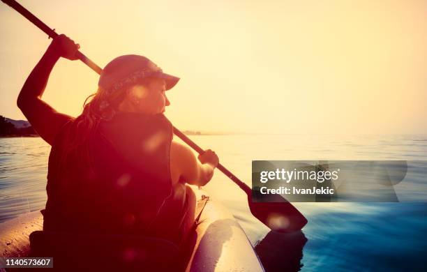 kayaking on the sea at sunset - life jacket photos stock pictures, royalty-free photos & images