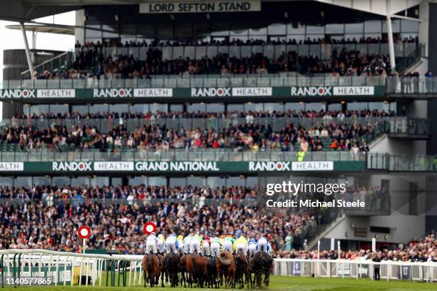 The runners and riders go past the main stand on the first lap in the Merseyrail Handicap Hurdle during Ladies Day at Aintree Racecourse on April 05,...