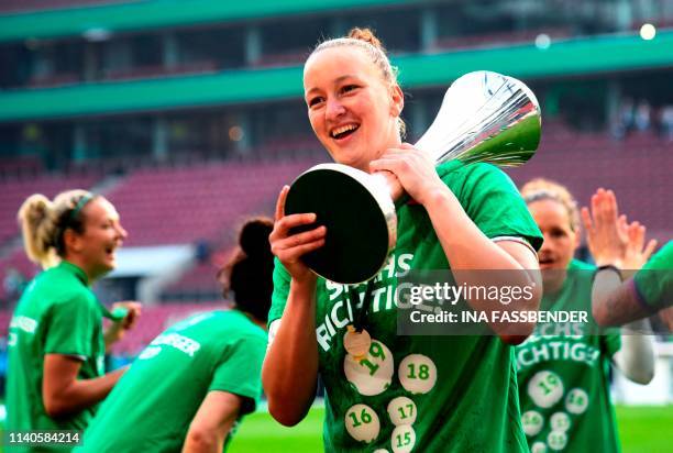 Wolfsburg's German goalkeeper Almuth Schult lifts the trophy after Wolfsburg won the Women's German Cup final football match VfL Wolfsburg vs SC...