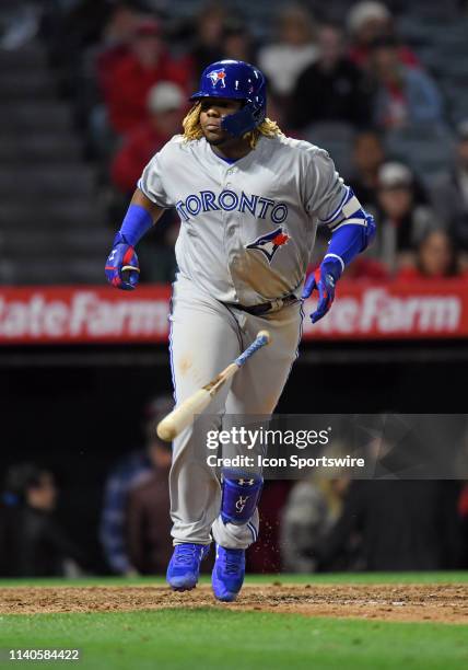 Toronto Blue Jays third baseman Vladimir Guerrero Jr. Tosses his bat after drawing a walk in the ninth inning of a game against the Los Angeles...