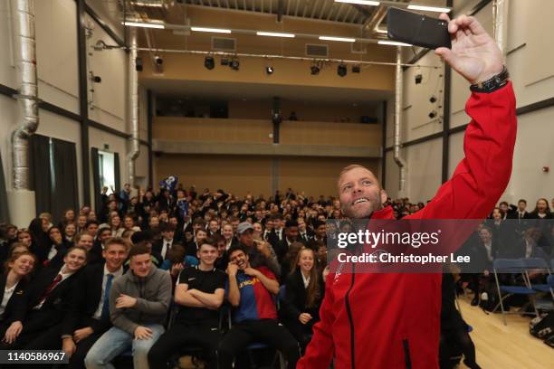 Eidur Gudjohnsen takes a selfie with children from the Three Rivers Academy during Day 1 of the UEL Trophy Tour Driven by Kia Visiting London on...