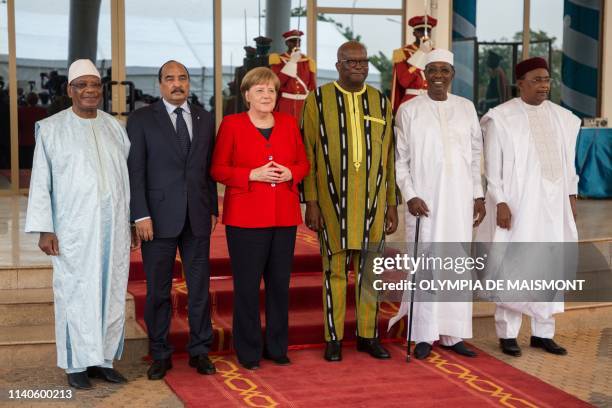 German Chancellor Angela Merkel poses for a group photo with Burkinabe President Marc Christian Kabore and the presidents of G5 Sahel, Chadian...