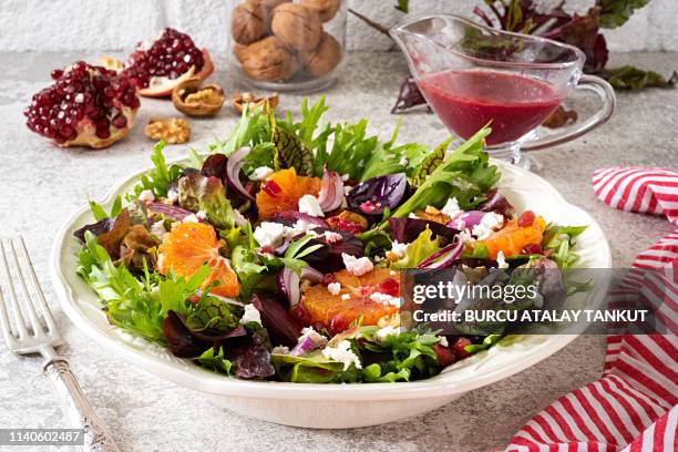 fresh salad with blood oranges, pomegranate, beetroot and feta cheese - bloedsinaasappel stockfoto's en -beelden