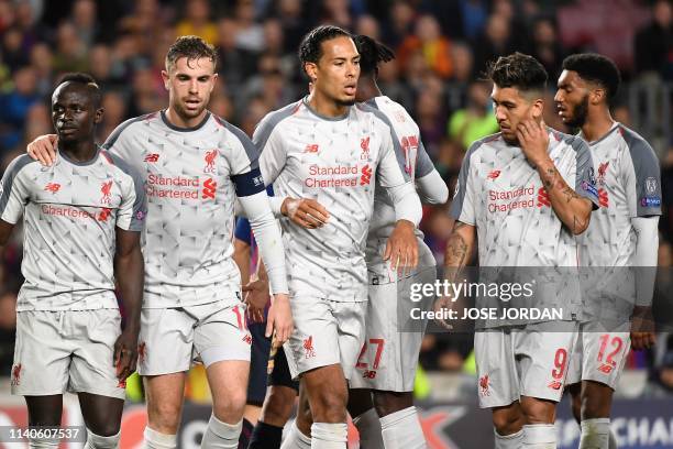 Liverpool's Brazilian midfielder Fabinho, Liverpool's Senegalese forward Sadio Mane, Liverpool's English midfielder Jordan Henderson, Liverpool's...