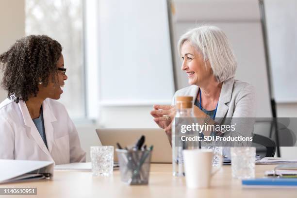 doctor meets with hospital administrator - medical sales representative stock pictures, royalty-free photos & images