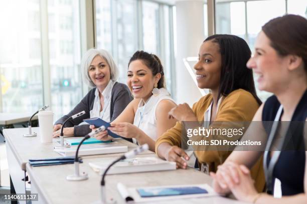 a panel of women present information - panelist stock pictures, royalty-free photos & images