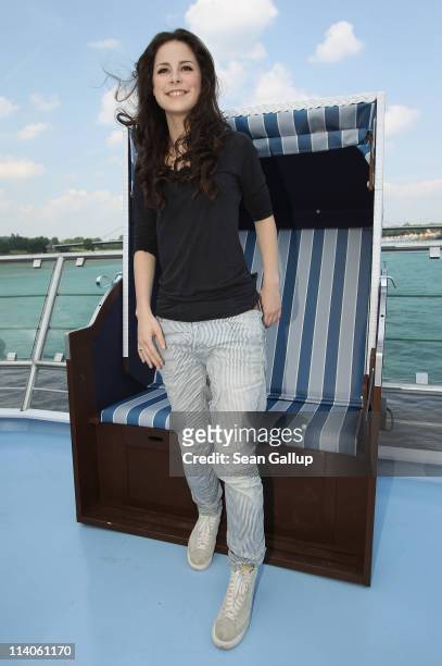 Singer Lena Meyer-Landrut of Germany poses in a beach chair while sailing on a ship on the Rhine River during the Eurovision Song Contest 2011 on May...