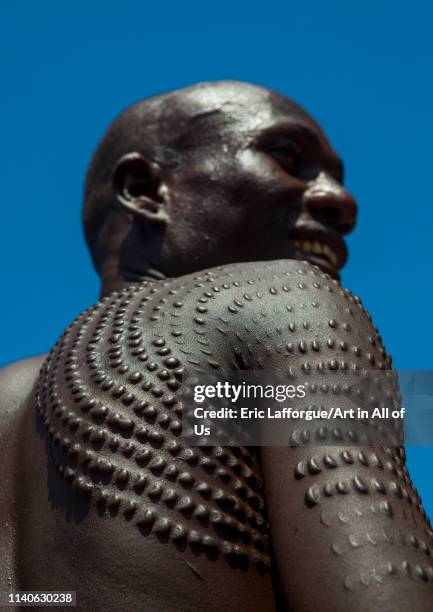 Topossa man with scarifications on his body, Kangate, Omo valley, Ethiopia on December 29, 2013 in Kangate, Ethiopia.