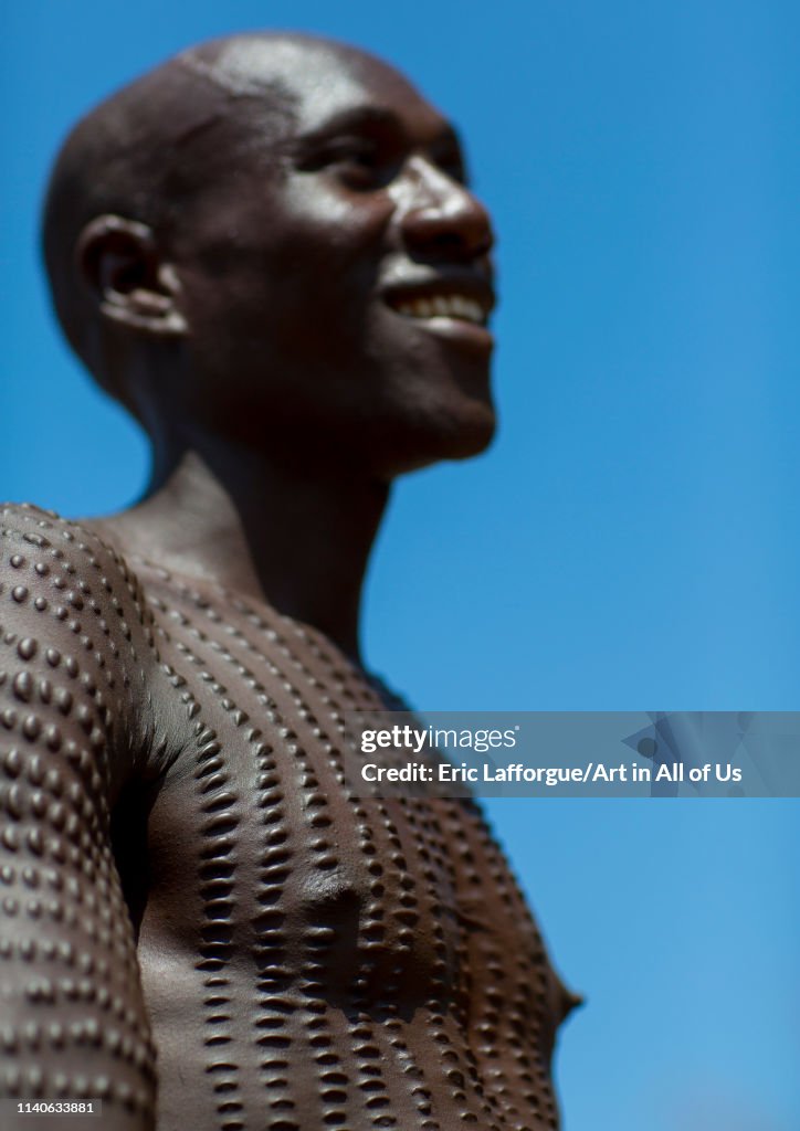 Topossa man with scarifications on his body, Kangate, Omo valley, Ethiopia...