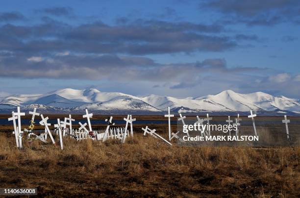 Cemetery sits on melting permafrost tundra at the Yupik Eskimo village of Quinhagak on the Yukon Delta in Alaska on April 12, 2019. - According to...